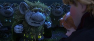 Trolls offer their assistance to Kristoff and Anna.
