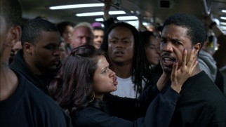 Sophina (Melonie Diaz) tries to calm Oscar (Michael B. Jordan) aboard the fateful BART (Bay Area Rapid Transit) train.