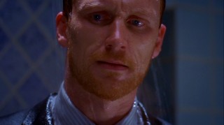 Owen (Kevin McKidd) makes a face that only a bearded man showering in a suit can.