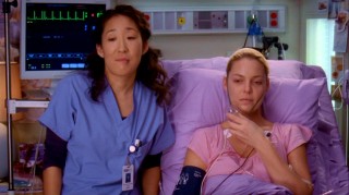 Two doctors, one healthy (Sandra Oh), one sickly (Katherine Heigl) look and comment upon Meredith's potential wedding dresses