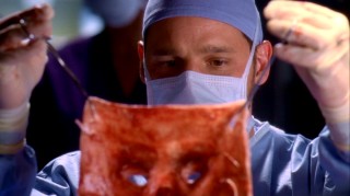 Alex (Justin Chambers) looks at the face he is to transplant in "Stand By Me."