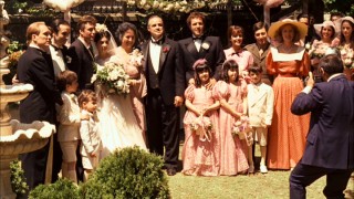 The Corleone family takes a big happy group photo on the day of Connie's wedding.