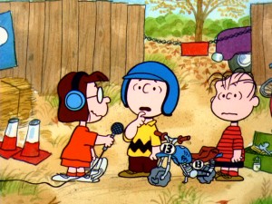 As announcer of the motocross race, Marcie doesn't let Charlie Brown or any of his competitors say very much.