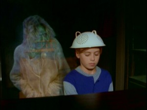 What's better than a boy playing piano with a colander on his head? A boy playing piano with a colander on his head and a ghost lurking over his shoulder.