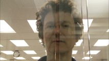 French director Michel Gondry clowns around with his nose between glass wall pieces in "Trust Me."