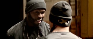 Rich Taylor (Curtis "50 Cent" Jackson) may be a serious businessman, but that doesn't stop him from flashing a smile while demonstrating his wares for a potential client.