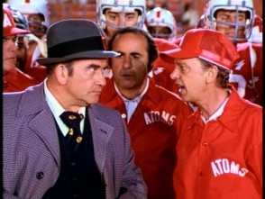 Hank (Ed Asner) glares at Coach Venner (Don Knotts).