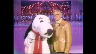 A costumed Snoopy skater stands next to Peanuts creator Charles Schulz in this windowboxed clip from one of the Redwood Empire Ice Arena's ice show TV specials.