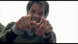 Timothy Olyphant laughs and looks at the camera in the Bloopers reel.