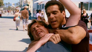 Playing himself Lou Ferrigno shows some of his Incredible Hulk muscle as he puts a disorderly Sydney (Jason Segel) into a sleeper hold.