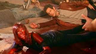 The life of an M. Night Shyamalan movie extra isn't as glamorous as Dee (Kaitlin Olson) had thought. Covered in blood, she objects to her second unit direction to keep her face down.
