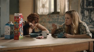 Lu (Nicole LaLiberte) and Shae (Danielle Panabaker) marvel at the nutritional value of Cap'n Crunch.