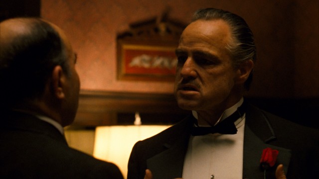 An aged Marlon Brando plays Don Vito Corleone, who hears requests on the day of his daughter's wedding in the opening scene of "The Godfather."
