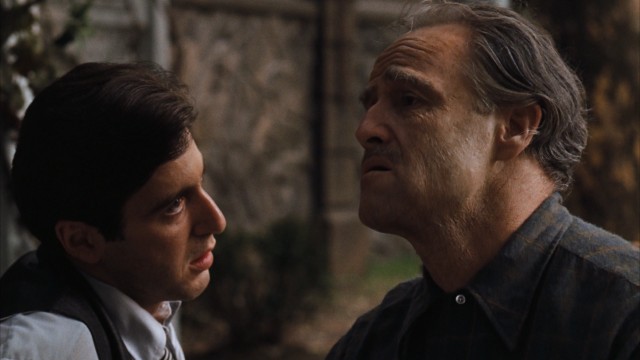The aging Don Corleone (Marlon Brando) shares a moment with the son (Al Pacino) who is about to take over the family business from him.