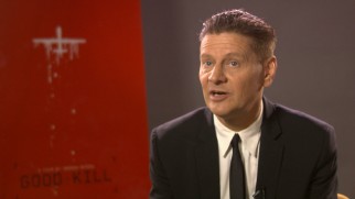 Writer-director-producer Andrew Niccol discusses his film alongside a teaser poster in "Good Kill: Behind the Scenes."