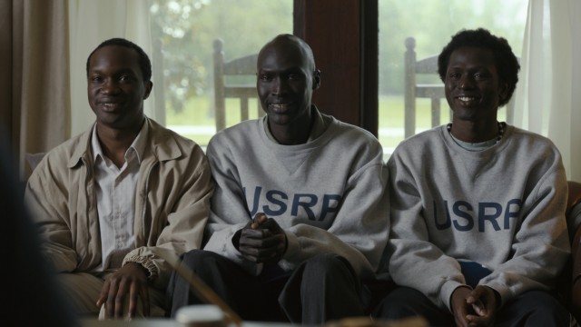In "The Good Lie", Sudanese refugees Mamere (Arnold Oceng), Jeremiah (Ger Duany), and Paul (Emmanuel Jal) learn the value of a fake smile on potential employees.