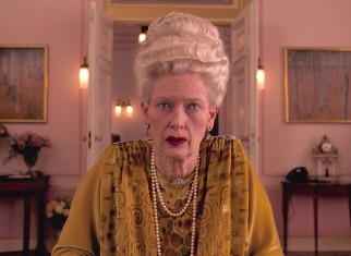 In a role originally intended for Angela Lansbury, a heavily aged Tilda Swinton portrays 84-year-old dowager Madame D.