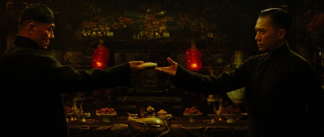 Grandmaster Gong Yutian (Wang Qingxiang) challenges Ip Man (Tony Leung) to break the cake in his hand in Wong Kar Wai's "The Grandmaster."