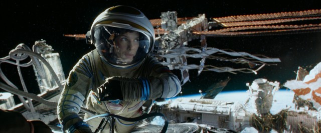 Rookie astronaut Dr. Ryan Stone (Sandra Bullock) clings to a space station for life in "Gravity."