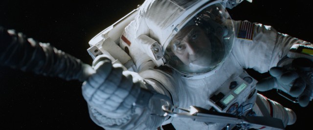 Calm veteran astronaut Matt Kowalski (George Clooney) tethers himself to Ryan Stone.