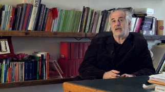 With a cigar in his hand and some videocassettes behind him, Toni Servillo talks about being four times a Sorrentino leading man.
