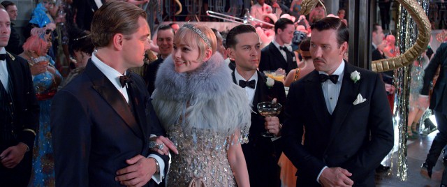 Nick Carraway (Tobey Maguire) is the fourth wheel to the love triangle involving Gatsby (Leonardo DiCaprio), Daisy (Carey Mulligan), and Tom Buchanan (Joel Edgerton).