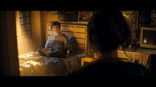A pre-teen version of Seth Rogen's character does some golden sunlight reading in front of a "Weird Science" poster in one of the two alternate openings.