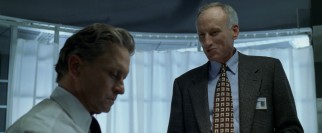 The screening stage small talk of CRS executive Jim Feingold (James Rebhorn) goes unappreciated by glum Nicholas (Michael Douglas).
