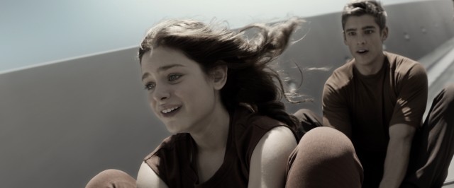 Fiona (Odeya Rush) and Jonas (Brenton Thwaites) enjoy a forbidden, spontaneous ride down the escalator bannister.