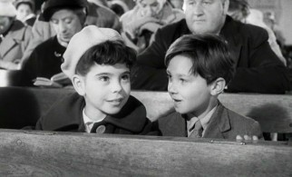 Sharing a pew with Mike (Philip Needs), Rachel (Loretta Parry) learns that Catholic mass isn't so bad.