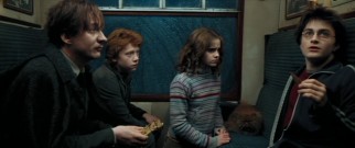 On the train to Hogwarts with friends Ron (Rupert Grint) and Hermione (Emma Watson), Harry (Daniel Radcliffe) gets a soothing piece of chocolate from new Dark Arts professor Lupin (David Thewlis) after a close encounter of the dementor kind.