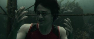 Fourth year wizard Harry Potter (Daniel Radcliffe) finds his hands webbing to aid him in the underwater challenge of the Triwizard Tournament.