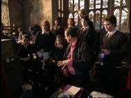 Director Mike Newell looks at playback with a group of Hogwarts students in Inside Harry Potter and the Goblet of Fire."