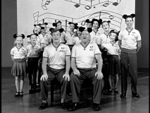 Jimmie and Roy lead a stage full of Mouseketeers in Fun with Music Day festivities.