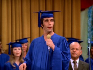 Night school valedictorian Arthur Fonzarelli addresses a distinguished audience, including assistant principal Dick Van Patten, at Jefferson High School's graduation.