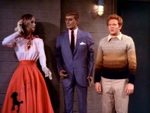 Ralph Malph (Donny Most) poses next to a 1950s mannequin couple while locked in Howard's hardware shop vault.