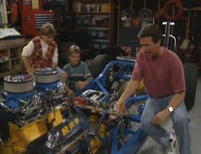 With the boys by his side, Tim tries to get his hotrod started.