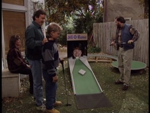 Tim and company find good use for Jill's unflattering driver's license blow-up with some homemade backyard mini golf.