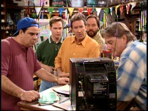 Benny, Marty, Tim, Al, and Harry gather around a TV at the hardware store to watch Jill badmouth her husband.