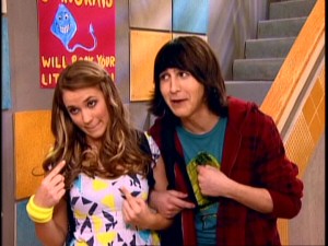 Lilly (Emily Osment) and Oliver (Mitchel Musso) are relieved not to worry about junior prom invitations. Now a couple, they're obviously going together.