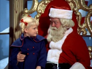 Cindy Brady (Susan Olsen) sits on Santa's lap and asks for something unusual in "The Voice of Christmas."