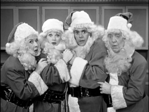 Ethel, Lucy, Ricky, and Fred are four Santa Clauses surprised by the just-vanished fifth at the end of the "I Love Lucy Christmas Show."