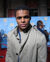Chris Warren Jr. (Zeke in "High School Musical" 1 and 2) looks serious in a trench coat on the sequel's red carpet DVD event.