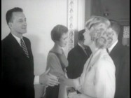 George C. Scott shakes hands with a guest at the premiere screening of "The Hustler", as seen in recycled featurette "The Inside Story."