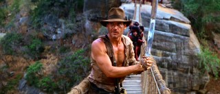 With opposition clearly approaching from both directions of this rope bridge, all Indiana Jones can do is wield a sword, flex, and look tough. Juggling the three is sure to make the short wait feel even shorter.