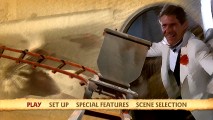 Indy's smug getaway smile shares the screen with a vacant mine car in the filtered animated main menu.