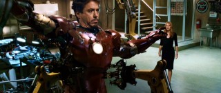 Pepper Potts (Gwyneth Paltrow) walks into Tony Stark's workshop to see her boss struggling to get out of his iron suit.