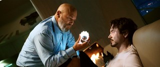 Friendly conversation or something else? Obadiah Stane (Jeff Bridges) looks at the arc reactor keeping an unusually pale Tony Stark alive.