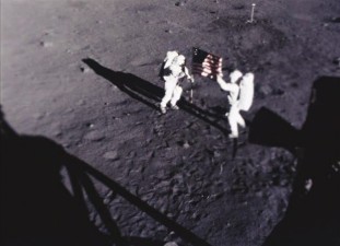 Neil Armstrong and Buzz Aldrin affix the United States flag to the lunar surface on Apollo 11.