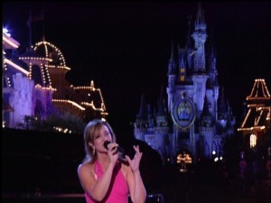 Ann Cochran wears pink and is complemented by the sight of Cinderella's Castle in back